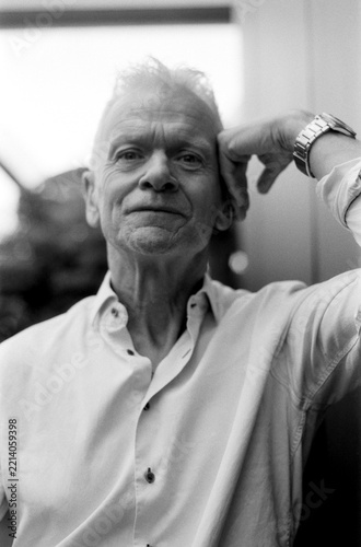 Photography Older man thinking, hand touching head in monochrome film grain