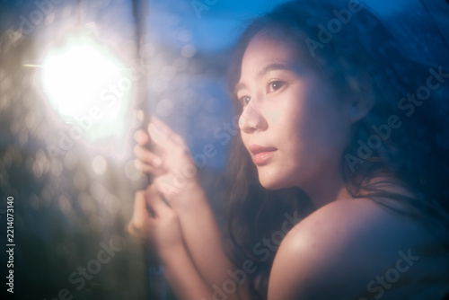 Young woman gazing into sunlight with natural beauty in outdoor setting