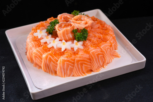 Salmon sushi styled to resemble a cake—a dish designed as a birthday gift. Use rice hidden inside instead of cake or bread. Japanese food.