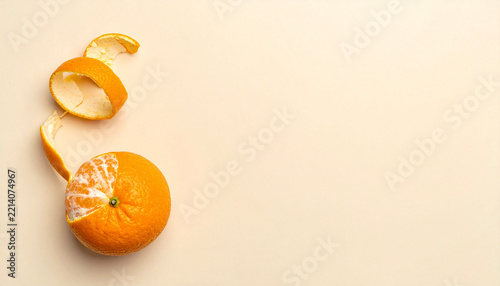 Clean commercial image of whole orange with a long spiral of citrus peel