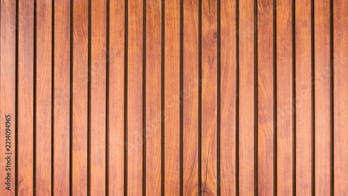 Landscape Wide View of Vertical Brown Wood Panel Background Featuring Hardwood Grain, Warm Red Oak Timber Strips, and Natural Wooden Floor Texture with Narrow Gaps Dark Space