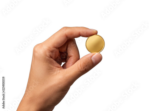 Person holding a small round gold coin in fingertips