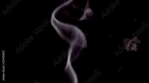Rising delicate white smoke trail against a pitch black background a graceful
