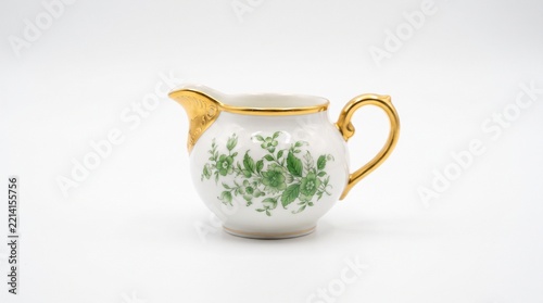 Vintage porcelain creamer with green floral pattern and gold gilded handle, antique white ceramic milk jug, elegant bone china tea service tableware