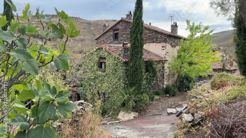 Patones traditional stone house covered in ivy in patones de arriba