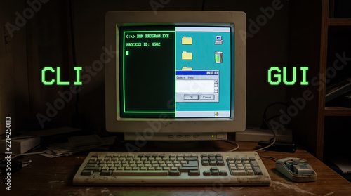 Computer monitor keyboard desk retro vintage command line graphical interface CLI GUI technology old classic workspace screen folder recycle bin window process text icon digital software operating