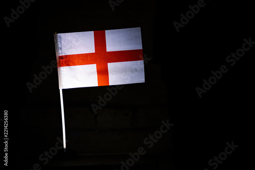 Photography Flag of England bearing the red St George cross shines against a black backgroun