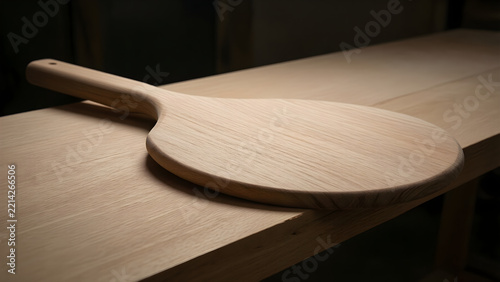Wooden pizza peel with a broad tapered blade