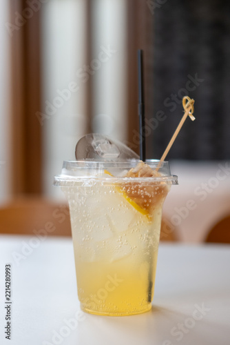 Iced honey lemon soda topped with a fresh honeycomb piece on a cafe table.