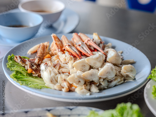 Steamed crab meat and crab claws served on a plate with dipping sauce
