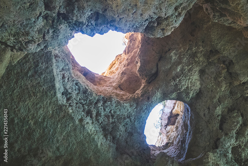 Rock cave interior with openings to sky, Marinha Beach, Benagil, Algarve, Portugal