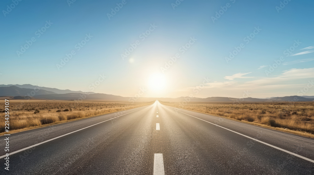 Fototapeta premium Open road through desert landscape beneath bright sun evokes freedom and adventure