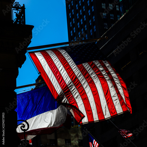 United States and French flags between historic city facades