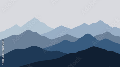 Overcast Gray Sky Above Endless Blue Mountain Ranges Fading into the Distance