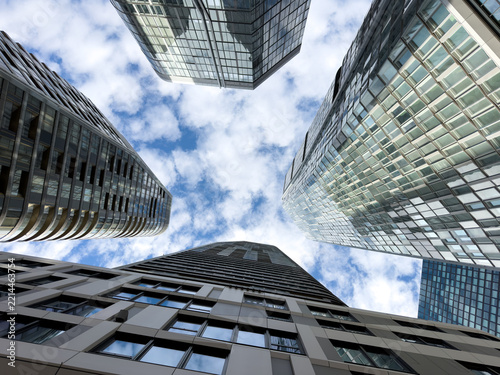 modern office buildings with reflections under blue sky 