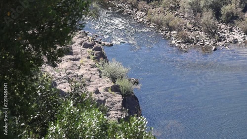 Scenic zêzere river flowing through a rocky landscape in portugal