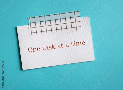 A card with text written - One Task At A Time - To focus attention on a single activity - Single Tasking or not multitasking.