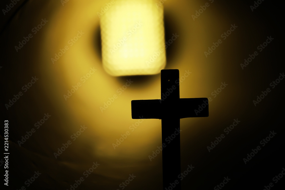 Fototapeta premium Silhouette of a Cross Against Bright Tunnel Light in Symbolic Spiritual Scene