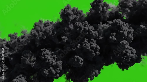 A thick black smoke cloud billowing and expanding across a solid green screen background, perfect for VFX transitions, disaster, and special effects.