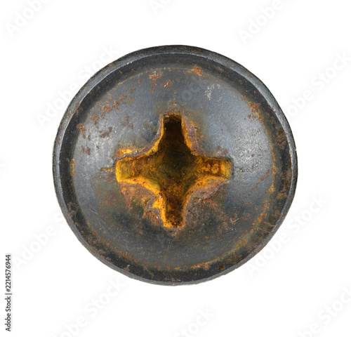 Large circular metal fastener with a prominent cruciform recess and heavy surface rust patina