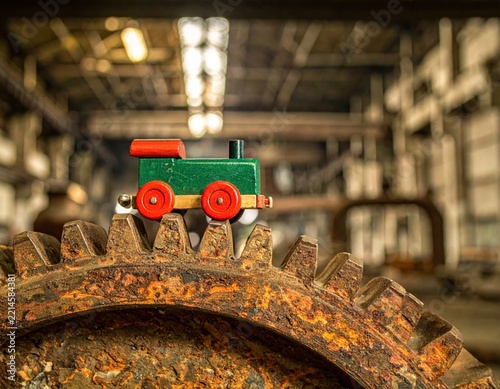 Toy Train on Rusty Gear in Factory