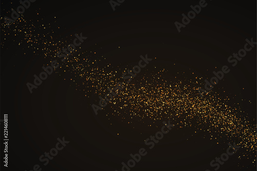Golden scattered glitter particles forming flowing wave shape on dark textured elegant background.