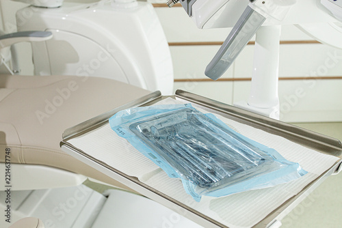 Sterile medical instruments, lying on a tray in protective packaging, dentist's instruments, preparation for a medical procedure.