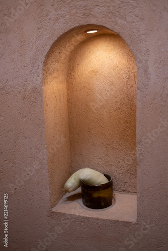 Brown jar in a warmly lit wall niche