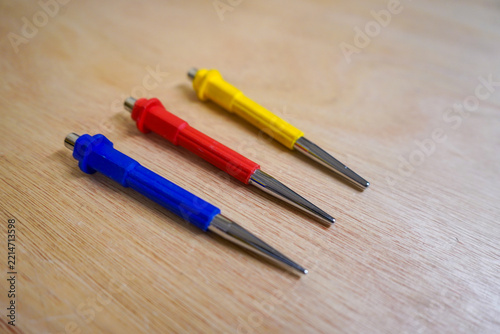Three tool punches on a wood background