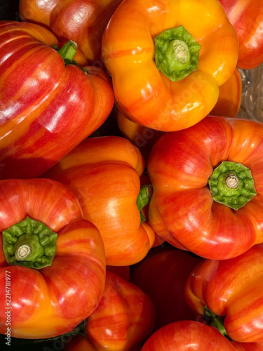 Colorful Ripe Red and Orange Bell Peppers in Supermarket Produce Display