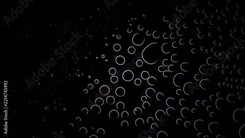 Hydrogen peroxide reaction creating oxygen bubbles under darkfield microscopy background 
