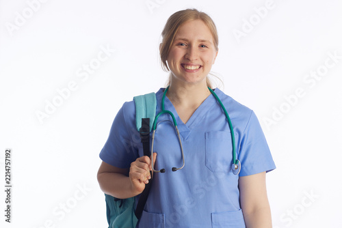 A portrait of a dedicated young nursing student wearing blue scrubs and a backpack, symbolizing the start of a professional healthcare journey and academic preparation.