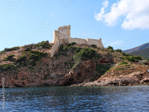 Girolata Genoese fort with navigation sign on rocky headland Corsica