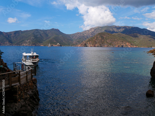 Girolata boat shuttle dock with Mediterranean bay and fortress backdrop Corsica
