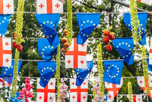 Georgian and European Union flags hanging on a city street
