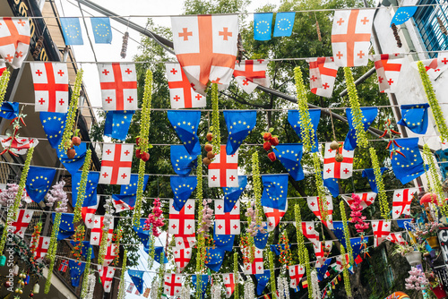 Georgian and European Union flags hanging on a city street
