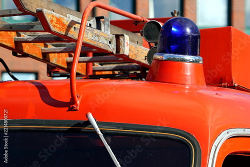 Red fire truck with blue light and ladder