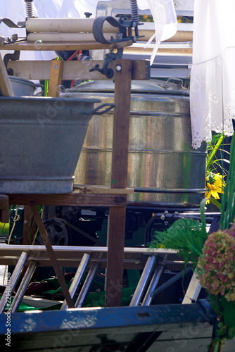 White milk can on green cart