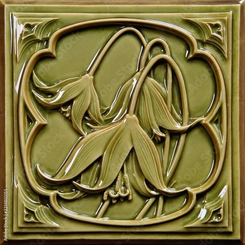 Elegant green ceramic tile featuring intricate floral motifs in an ornate Art Nouveau style, with glossy finish and flowing lines for decorative appeal.