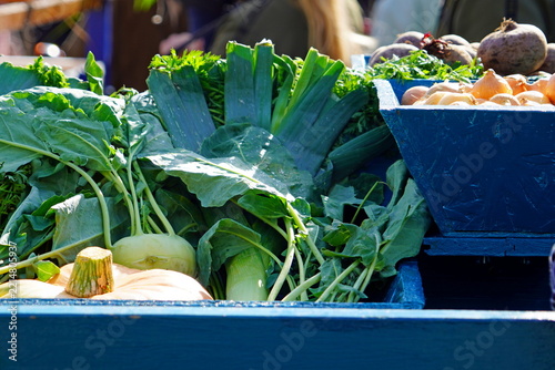 Fresh vegetables in blue market bins
