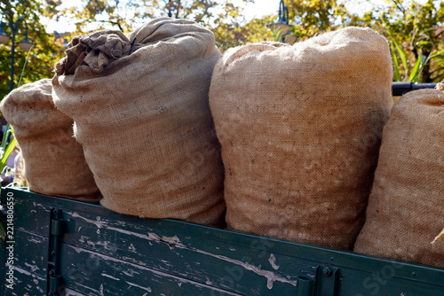 potatoe sacks and wicker basket on red cart