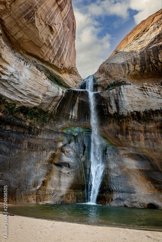 Lower Calf Creek Falls, about 15 miles east of Escalante, Utah, is a 126-foot desert oasis waterfall located along Utah Scenic Byway 12 in the Grand Staircase-Escalante National Monument.