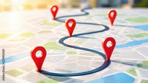 A map with a winding road and red location pins marking a route across a city street grid layout des