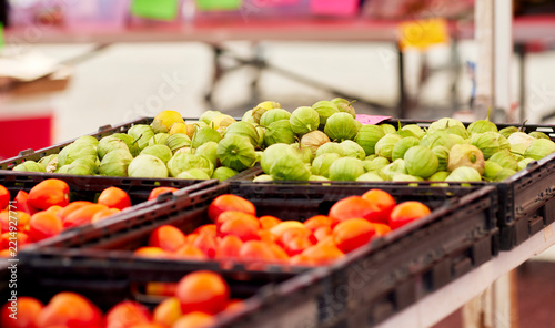 Baskets of fresh tomatoes for sale at an outdoor farmer's market