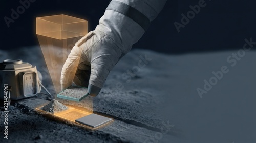 Person's hand delicately touching a small object on the surface of a realistic model of the moon