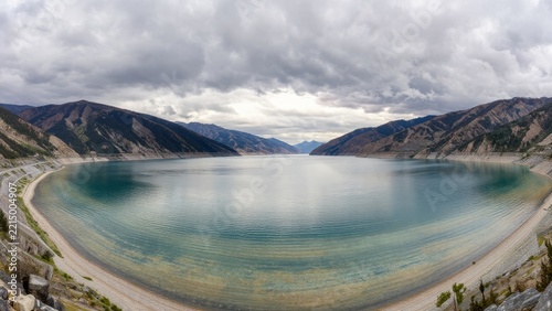 Serene View of Tranquil Lake Surrounded by Mountain Landscape
