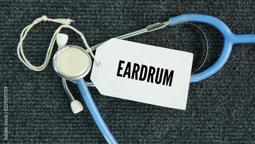 Fotografie Stethoscope and paper tag with the word eardrum, or tympanic membrane, is a thin, cone-shaped piece of tissue that separates your outer ear canal from your middle ear