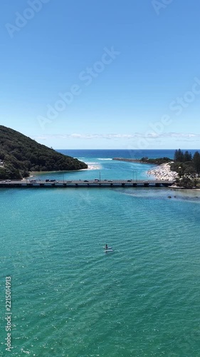 Tallebudgera Creek estuary from above, calm green water and golden sand, Gold Coast, Queensland Australia - vertical video