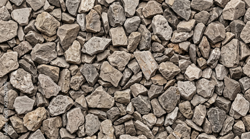 Close-up of various sized gray and green gravel stones, creating a textured background.
