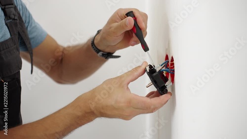 Man installing new electrical outlet during renovation
